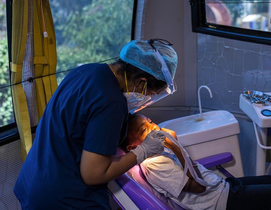 how-is-cleft-treated Dental hygenist working on a child sitting in a dental chair
