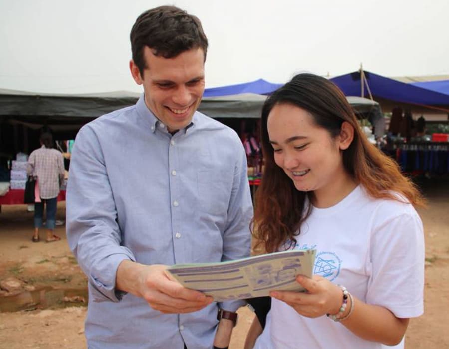 imapct-report-accountability Hugh Brewster and a volunteer both smile as they look at a report together