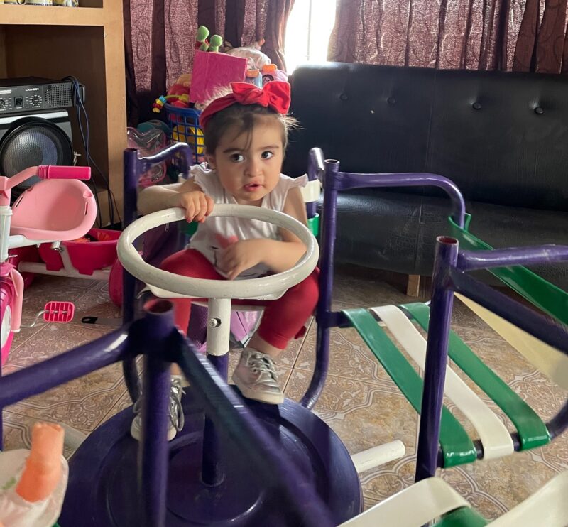 Georgina, born with cleft, plays with her toys