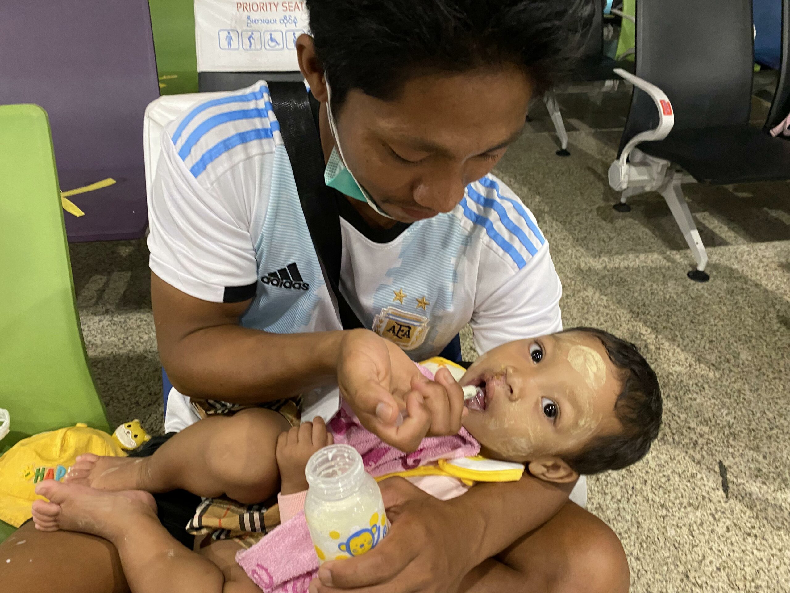 Yoon-2_Myanmar_Cleft_Surgery Yoon’s Father syringe feeds her during the travel back after surgery.