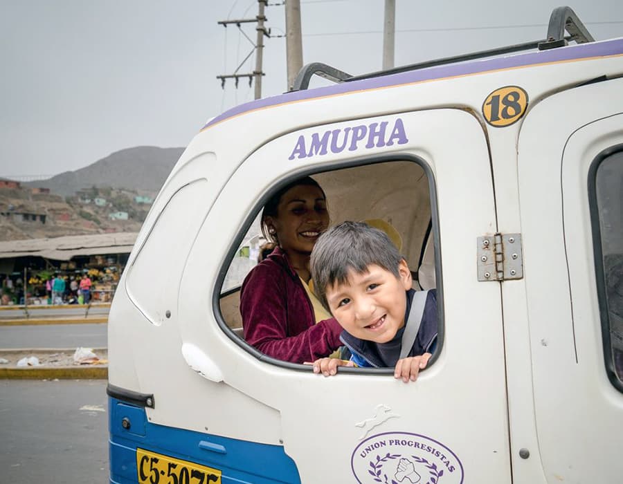 why-cc-shared-impact A smiling child leaning out of a van window with his mother smiling in the background